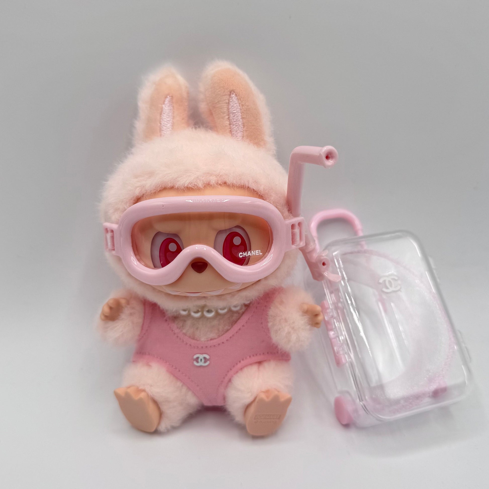 Labubu Pink Chanel swimsuit with diving goggles and suitcase